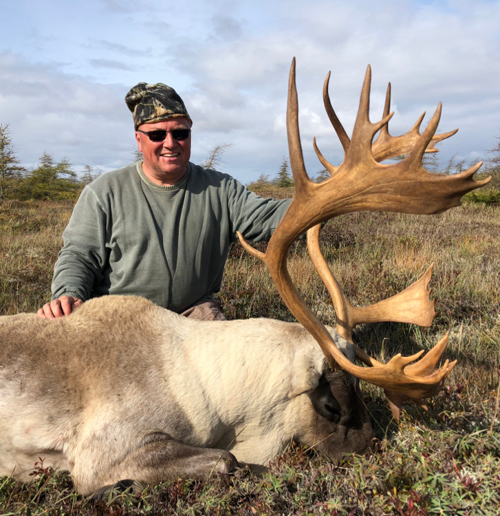 man with woodland caribou